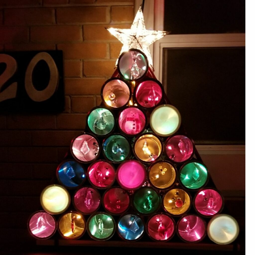 Light up christmas tree yard art made from coffee tins